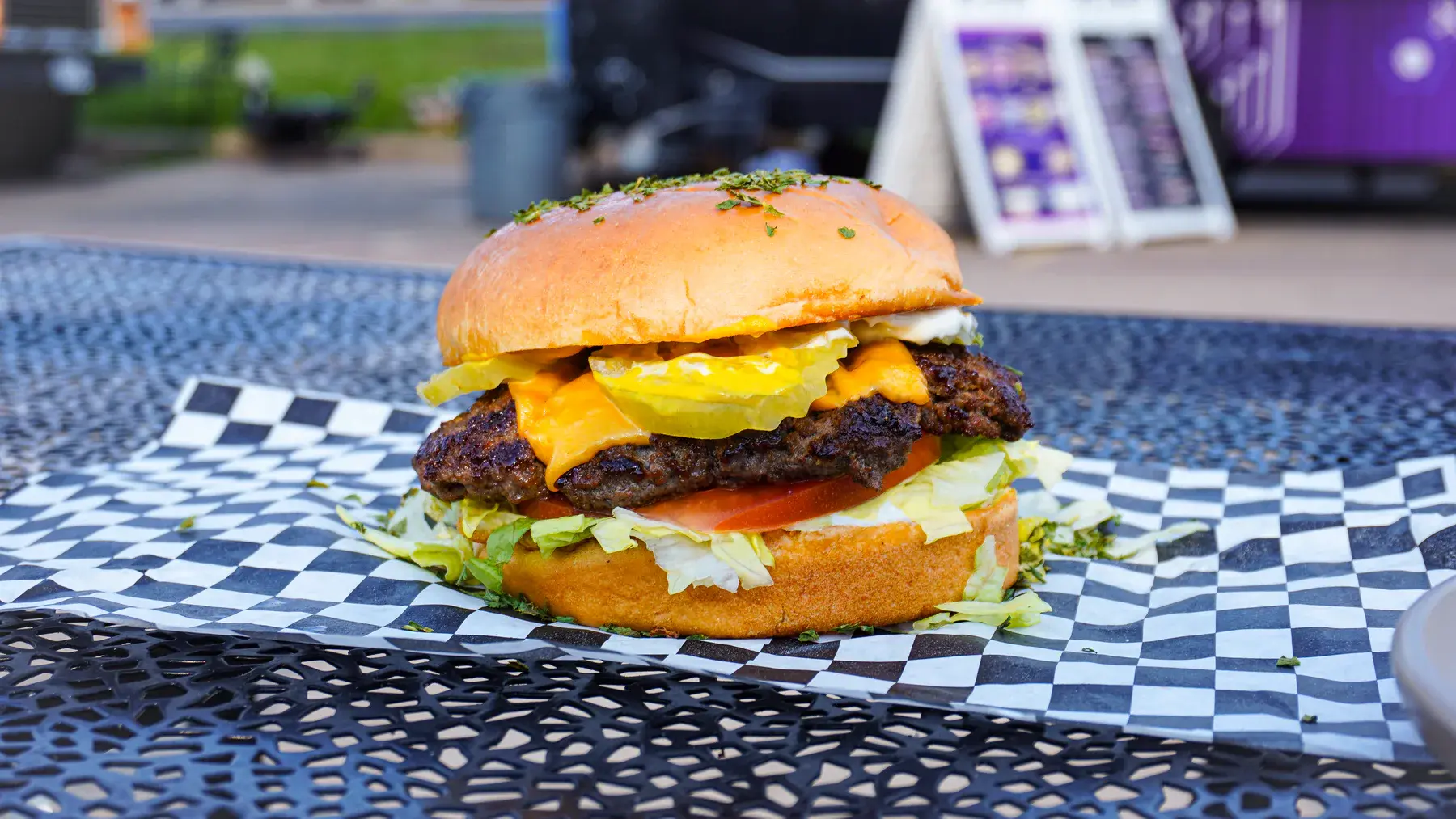 DeFi Burger classic cheeseburger with lettuce, tomato, pickles, mayo, and mustard