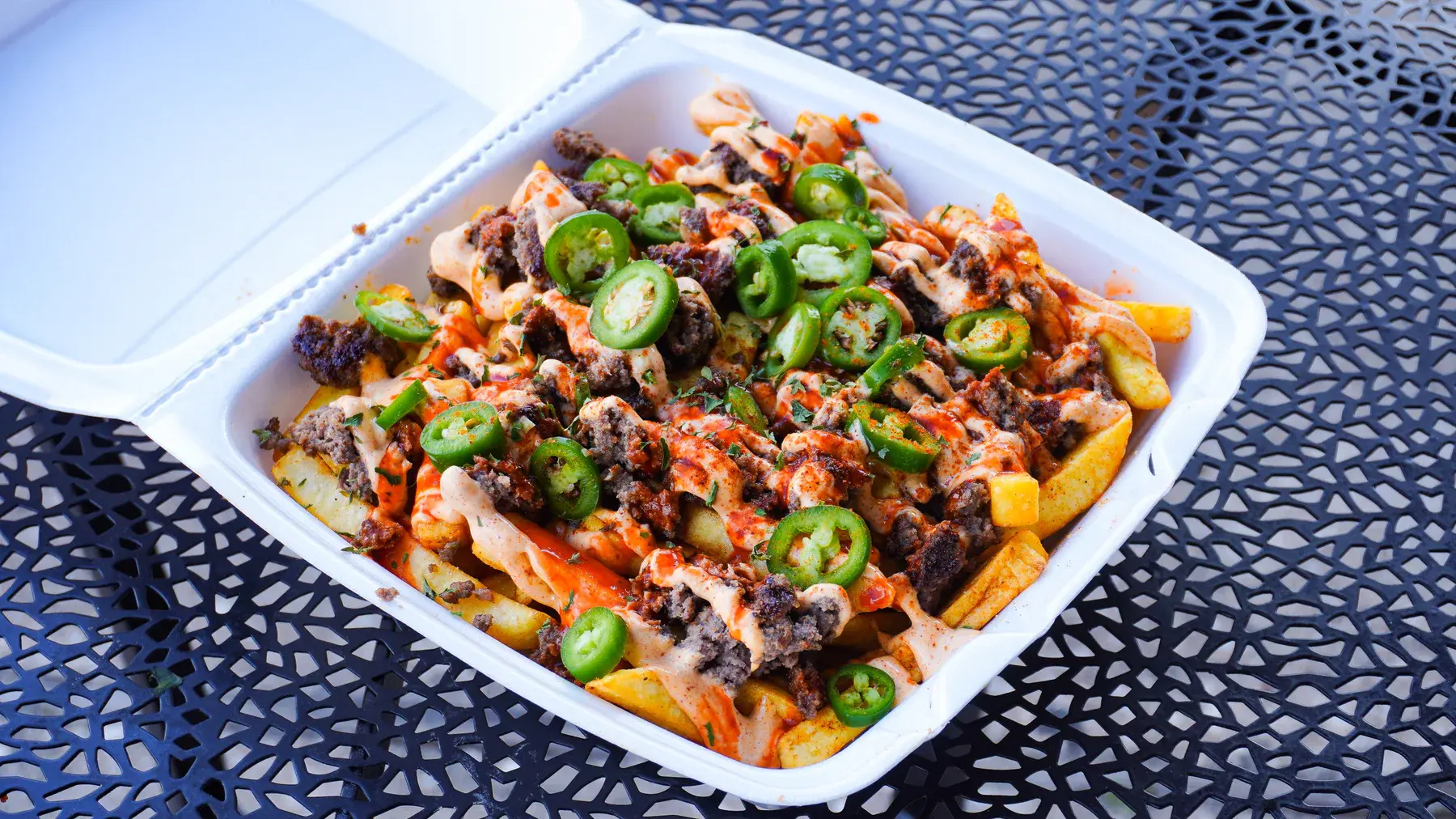 Spicy Metaverse Monster Fries with beef, peppers, spicy FOMO sauce, and cayenne